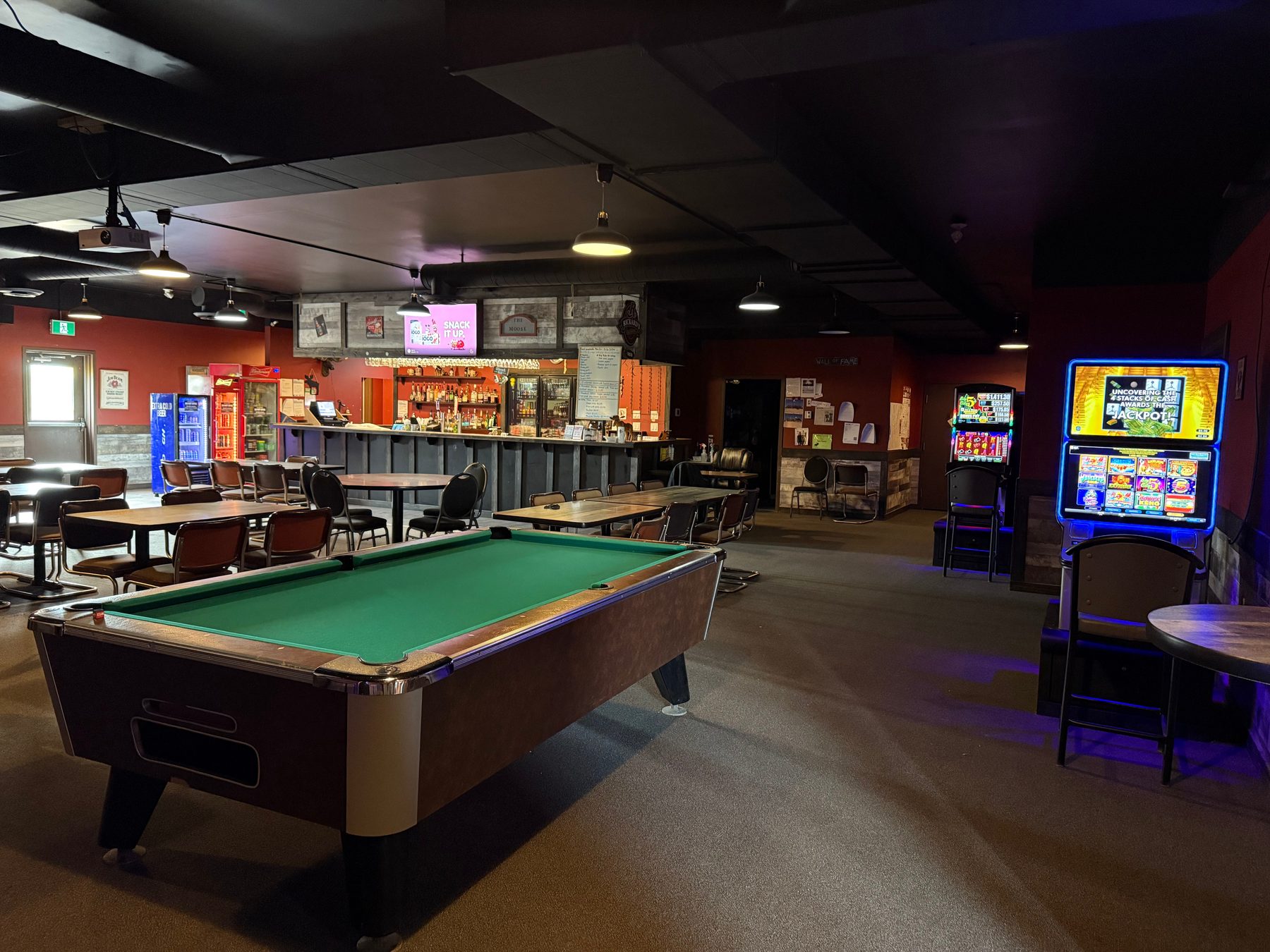 Pool table and lounge seating inside Moosehorn Motor Hotel