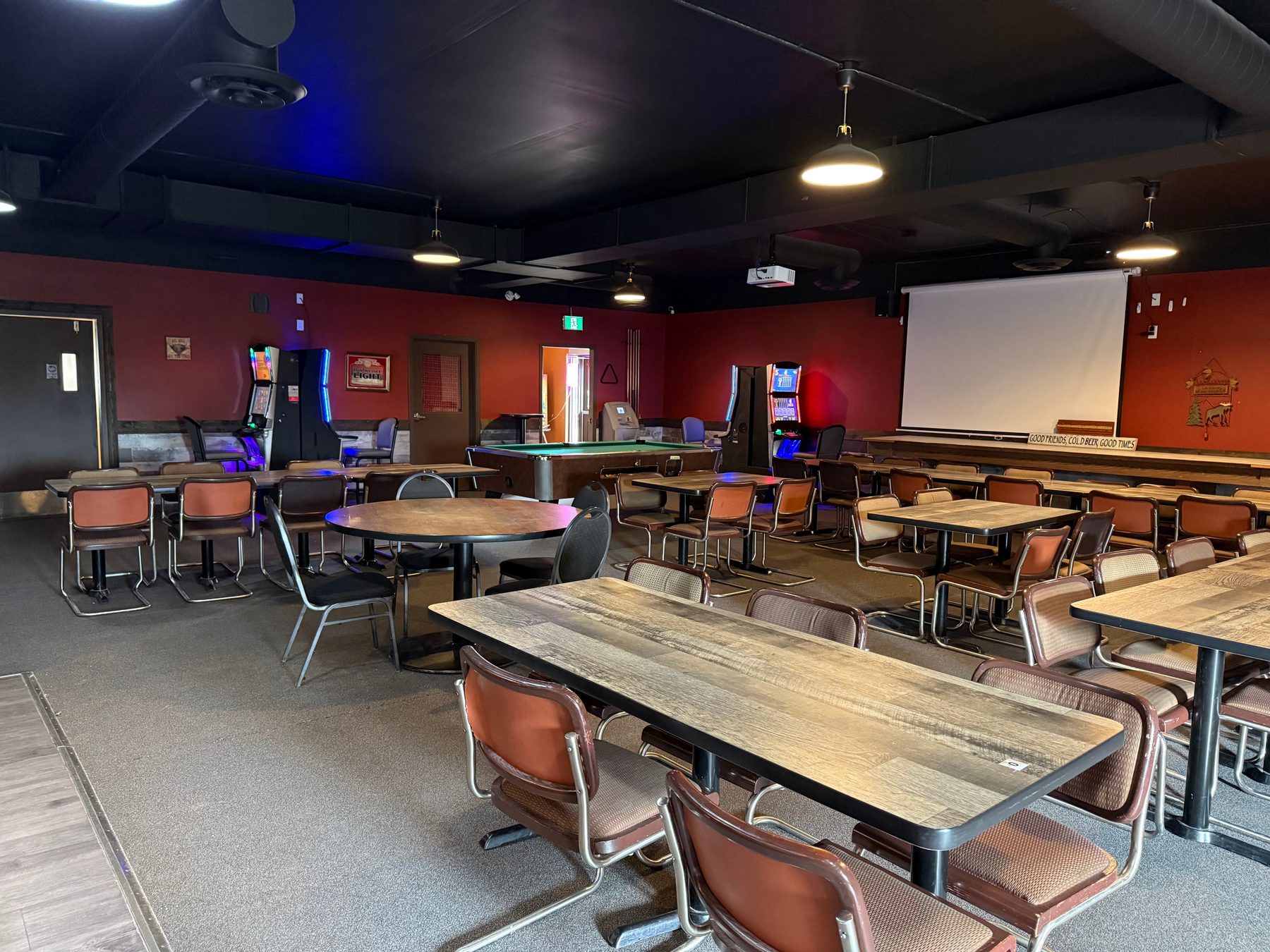 Tables, chairs and VLT area inside the Moosehorn Motor Hotel lounge