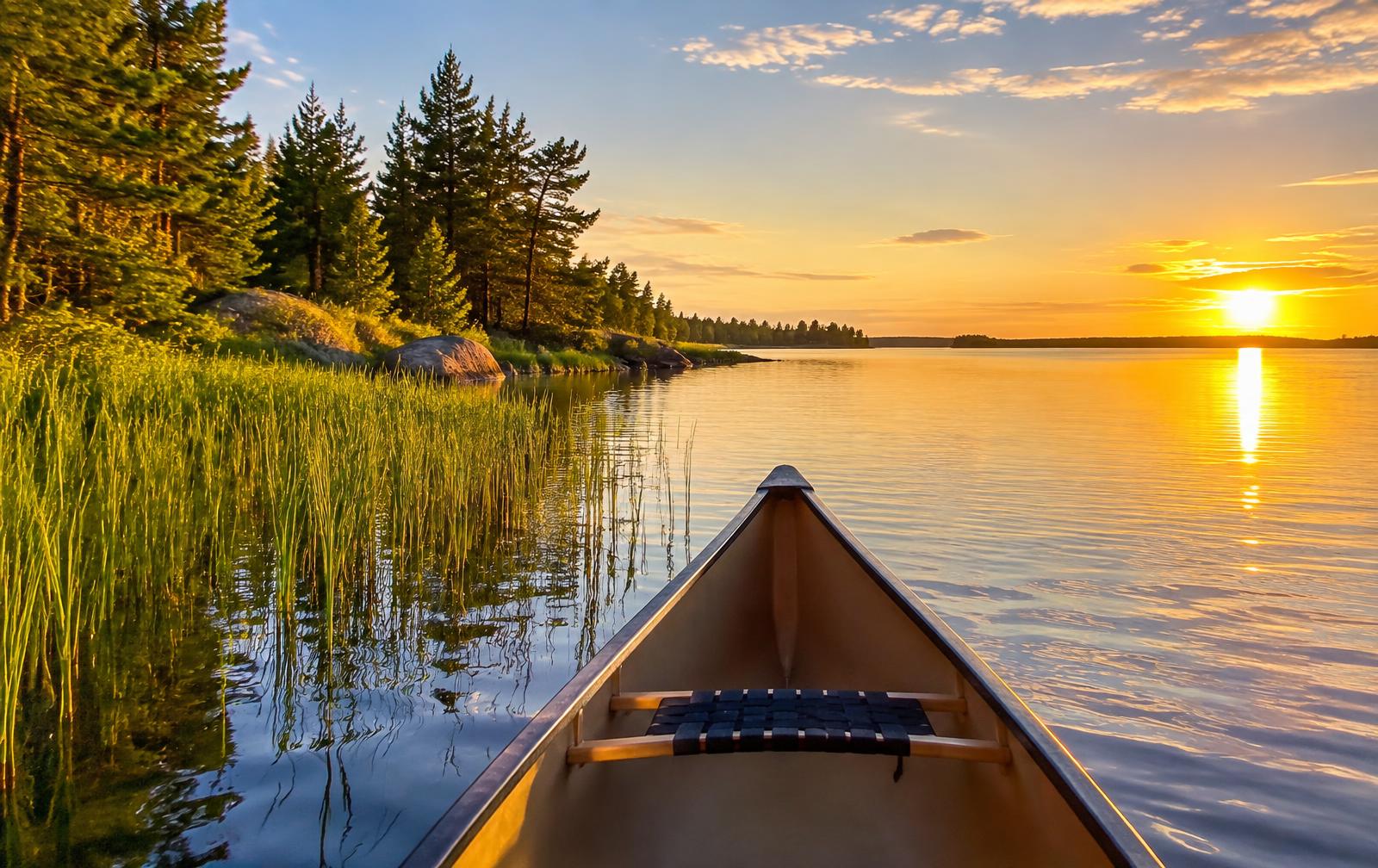 Canoe bow on a calm northern lake at golden hour